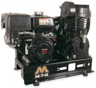 A black engine with two air compressors on top of it.